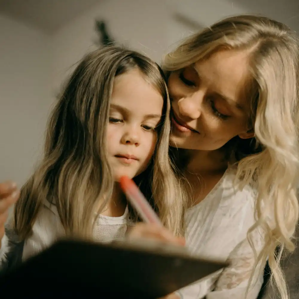 Tutor teaching a child at home to support early learning and development